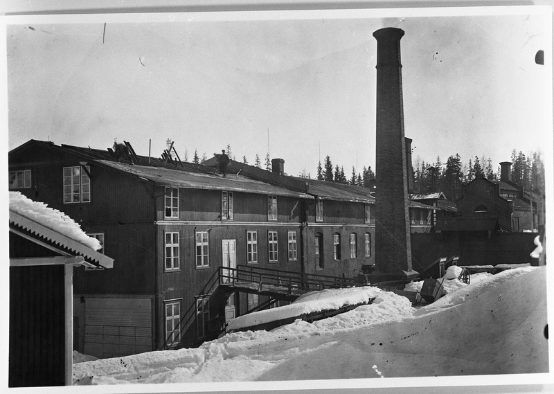 Raufoss Patronfabrikk ca. 1904. Bildet viser den gamle fabrikkbygningen. Det er den gamle fyrstikkfabrikken som er en del ombygd. Brua som vi ser fører inn til et forsamlingslokale som arbeiderne hadde her i mange år.